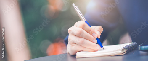 Obraz na płótnie Business woman hand writing on a notepad with a pen in the office. w salonie