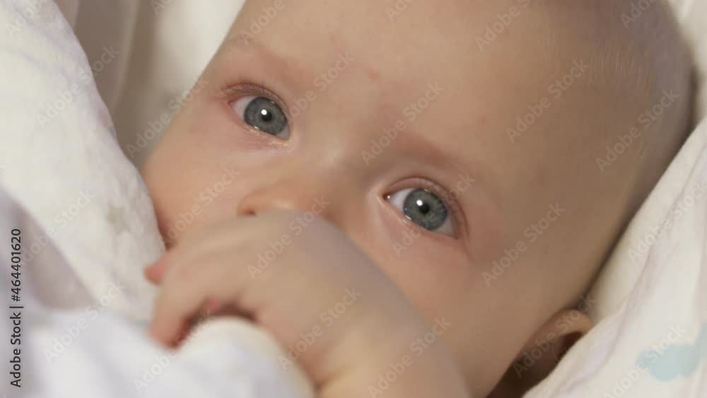 Baby falling asleep in baby rocker afternoon nap, caucasian six month old infant face closeup. High quality 4k footage Baby falling asleep in baby rocker afternoon nap, caucasian six month old infant face closeup. High quality 4k footage