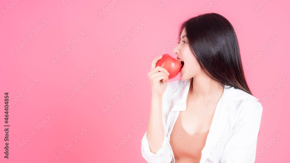 beautiful Asian woman cute girl feel happy eating red apple fruit for good health isolated on pink background with copy space - lifestyle healthy woman concept beautiful Asian woman cute girl feel happy eating red apple fruit for good health isolated on pink background with copy space - lifestyle healthy woman concept