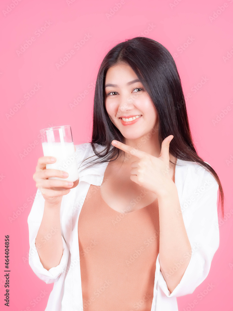 beautiful Asian woman cute girl feel happy drinking milk for good health in the morning on pink background - lifestyle beauty woman concept beautiful Asian woman cute girl feel happy drinking milk for good health in the morning on pink background - lifestyle beauty woman concept