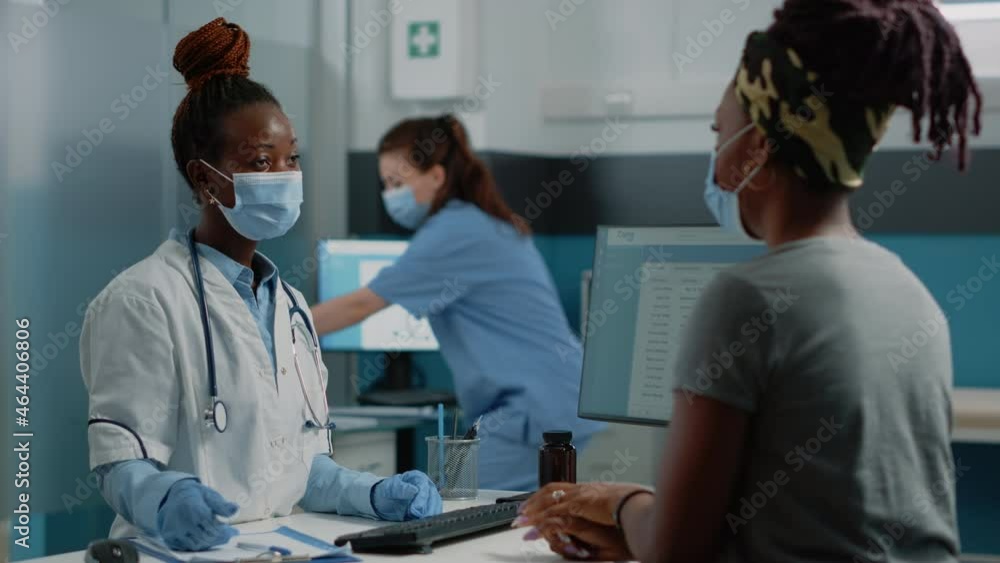 Doctor holding x ray scan to explain bones diagnosis to patient at medical consultation. Medic showing radiography for healthcare and examination to woman with sickness, looking at results Doctor holding x ray scan to explain bones diagnosis to patient at medical consultation. Medic showing radiography for healthcare and examination to woman with sickness, looking at results