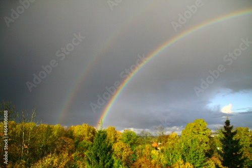 Rainbow in the rain, with sunny glades