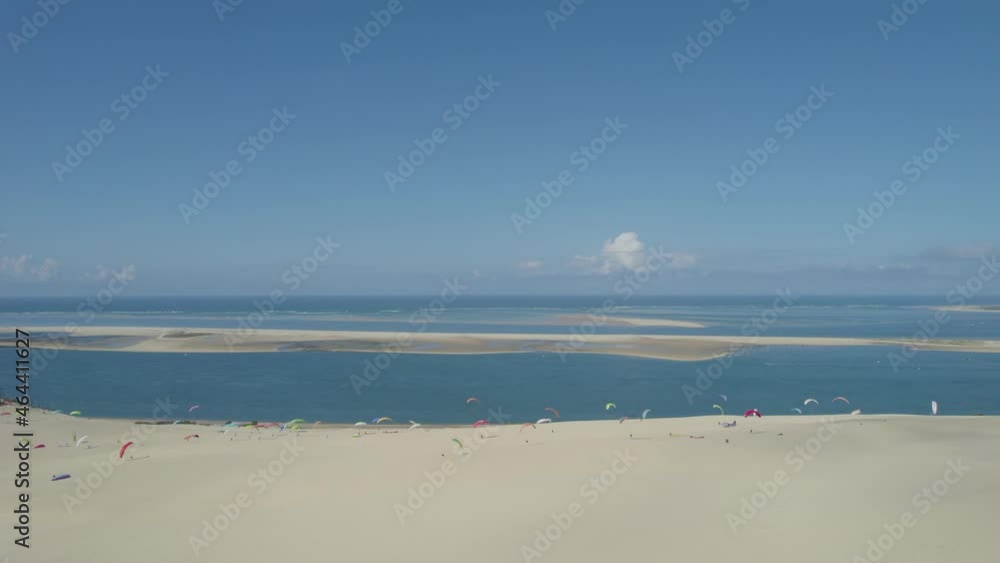 Dune of Pilat with paragliders at the top taking flight at Arcachon Bay France, Aerial pedestal down shot Dune of Pilat with paragliders at the top taking flight at Arcachon Bay France, Aerial pedestal down shot