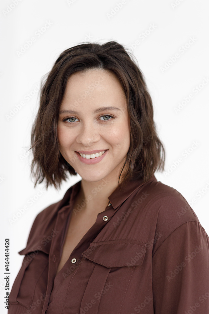 A young beautiful pregnant woman in a burgundy dress on a white background. Pregnancy, a studio with an empty background. A young beautiful pregnant woman in a burgundy dress on a white background. Pregnancy, a studio with an empty background.