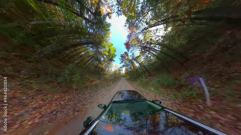 Amazing abstract perspective on a car driving down a country road amid colorful Autumn splendor, Fall colors, aerial super-wide angle view. Amazing abstract perspective on a car driving down a country road amid colorful Autumn splendor, Fall colors, aerial super-wide angle view.