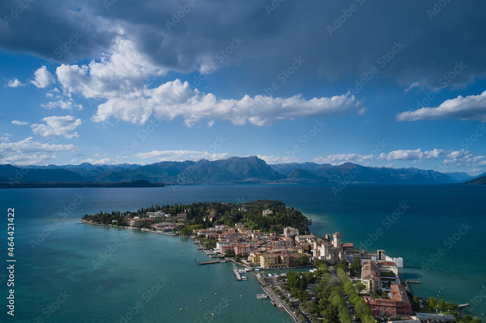 Sirmione, Lake Garda, Italy. Castle on the water in Italy. Aerial view of the island of Sirmione. Panorama of Lake Garda. Peninsula on a mountain lake in the background of the alps.