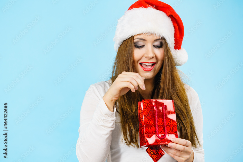Christmas woman puts her hand into gift bag Christmas woman puts her hand into gift bag