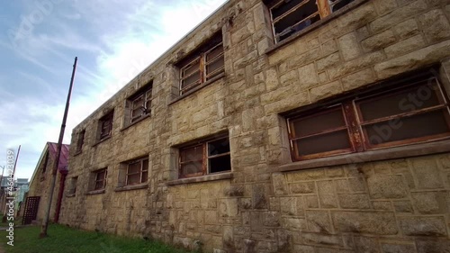 Moving shot of deteriorating prison cellblock exterior at Eastern State Penitentiary. photo