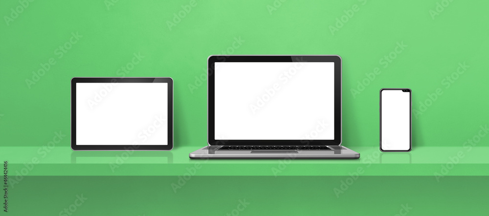 Laptop, mobile phone and digital tablet pc on green wall shelf. Banner background Laptop, mobile phone and digital tablet pc on green wall shelf. Banner background