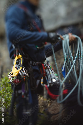 Abstract blurred image of a figure of a climber and climbing equipment, close-up.