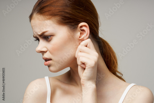 Wallpaper Mural sick woman ear pain health problem dissatisfaction light background Torontodigital.ca
