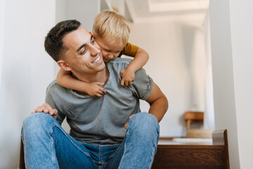 Young white father making fun and playing with his son on stairs
