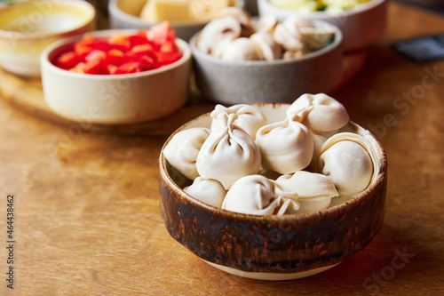 raw dumplings in a wooden bowl close-up