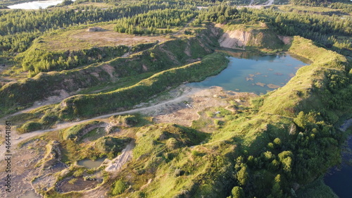 Flooded and overgrown sand quarry. Lush green summer landscape for outdoors vacation, hiking, camping or tourism. Volokolamsk district of Moscow region. Sychevo beach, Russia