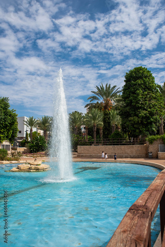 Fountains and palms in city garden park in Israel, Rishon Lezion. Summer landscape