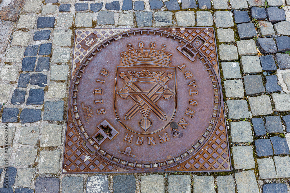 A manhole cover with coat of arms of Sibiu in Romania A manhole cover with coat of arms of Sibiu in Romania