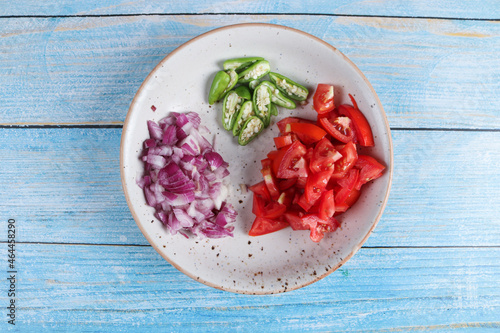 sliced onion, chilli, tomatoes on a plate