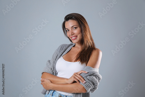 Portrait of beautiful woman on light grey background