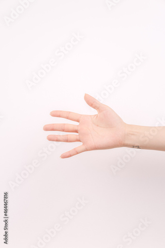 hand showing number five In front of the white background
