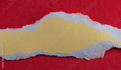 Yellow paper with torn marks on a red background. The image in the upper corner can be used as a background. with copy space and text area