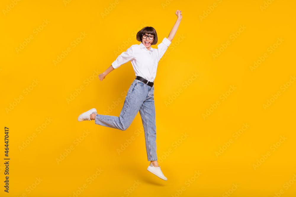 Photo of superhero business lady jump fly wear eyewear white shirt jeans shoes isolated yellow color background