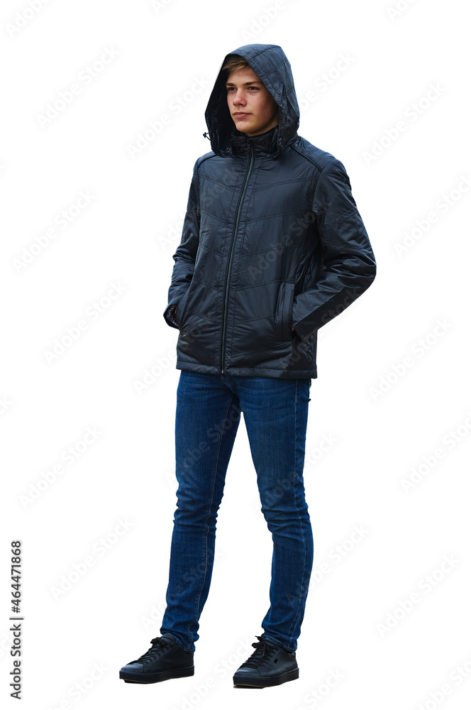 Young stylish man in leather jacket isolated on white. Hands in pockets. The hood is worn over the head. Jeans and shoes with laces.