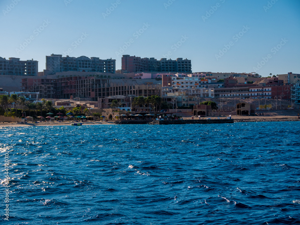 View from the sea of the coast of the resort town with hotels under construction.