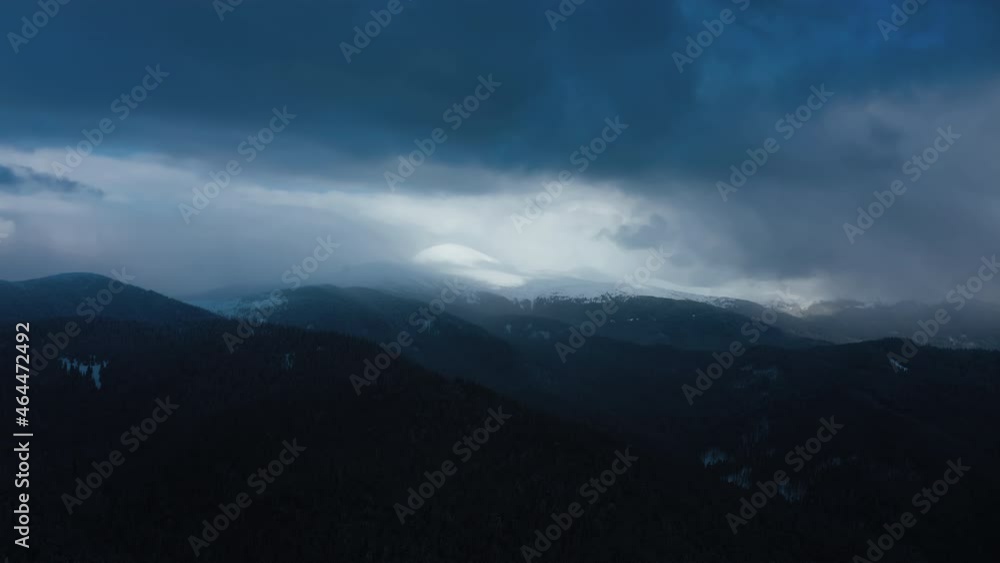 Aerial view of Heavy snowfall in Frozen mountains at winter. Flight above winter forest. Amazing winter landscape. Clouds covered mountains
Aerial view of Heavy snowfall in Frozen mountains at winter. Flight above winter forest. Amazing winter landscape. Clouds covered mountains
