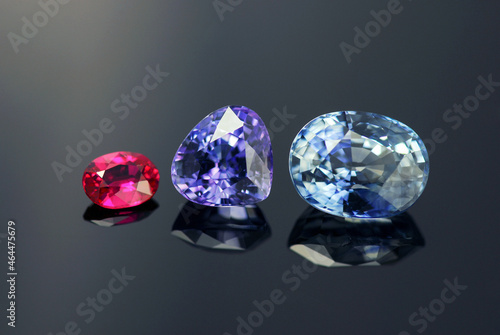 Natural corundum gemstones set. Winza unheated red ruby, Tanzanian purple sapphire, Ceylon light blue color sapphire faceted gemstone for making jewelry. Clean rare precious gems settings. Gemology.