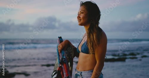 Portrait of beautiful woman kitesurfer on the beach at sunset, female extreme sports athlete, strong independent woman and diversity