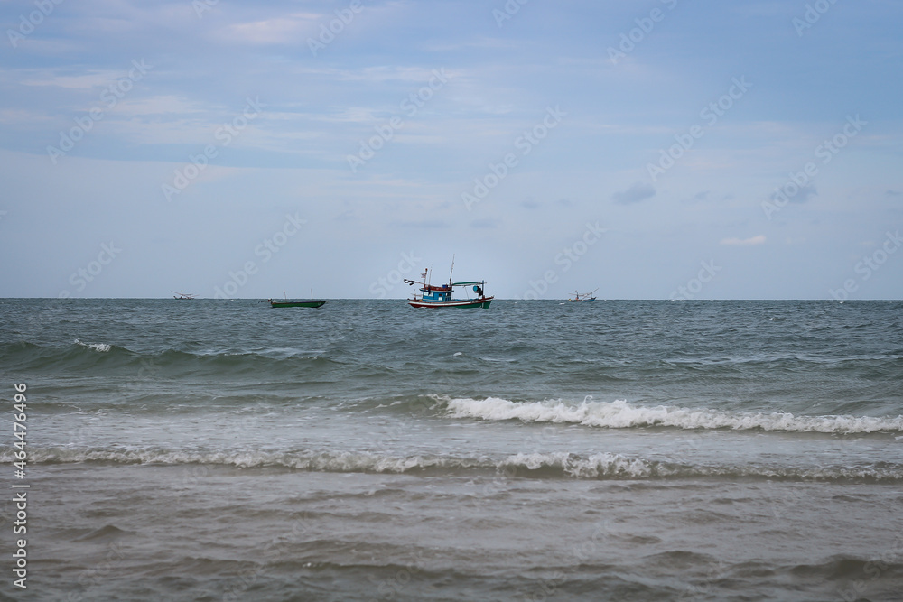 The fishing boat floats in the middle of the sea in the evening. The fishing boat floats in the middle of the sea in the evening.
