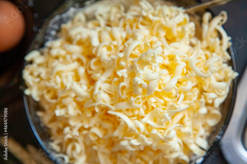 Grated butter for baking on table. Baking ingredients for shortbread pastry: grated butter, flour, eggs, sour cream on a wooden background photo