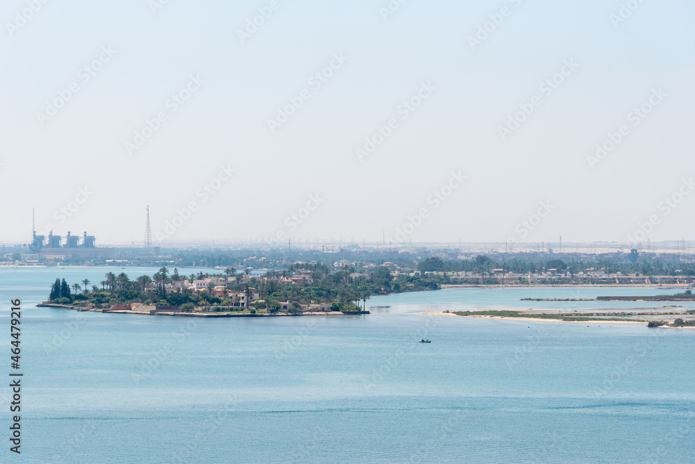 Banks of the Suez Canal, panorama view from transiting cargo ship. 