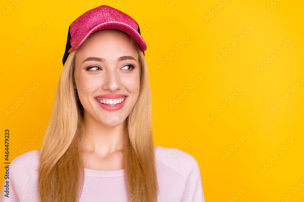 Photo of young cheerful girl happy positive smile curious look empty space isolated over yellow color background Photo of young cheerful girl happy positive smile curious look empty space isolated over yellow color background
