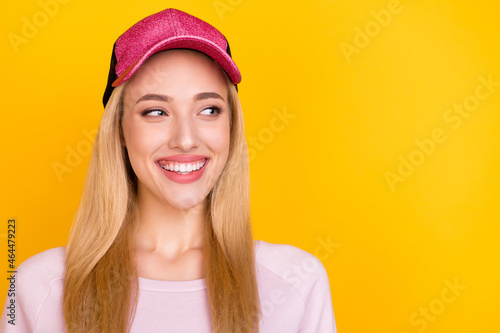 Photo of young cheerful girl happy positive smile curious look empty space isolated over yellow color background