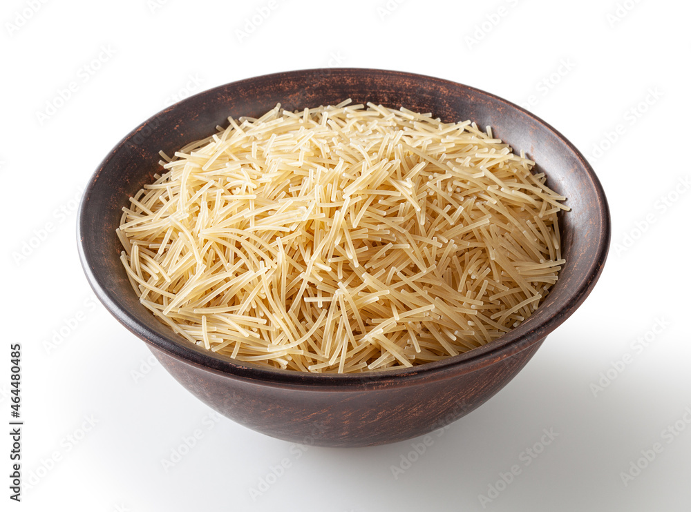 Uncooked vermicelli pasta in ceramic bowl isolated on white background with clipping path