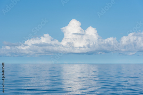 Beautiful blue sky, with fluffy clouds over the calm Pacific Ocean.  © Mariusz