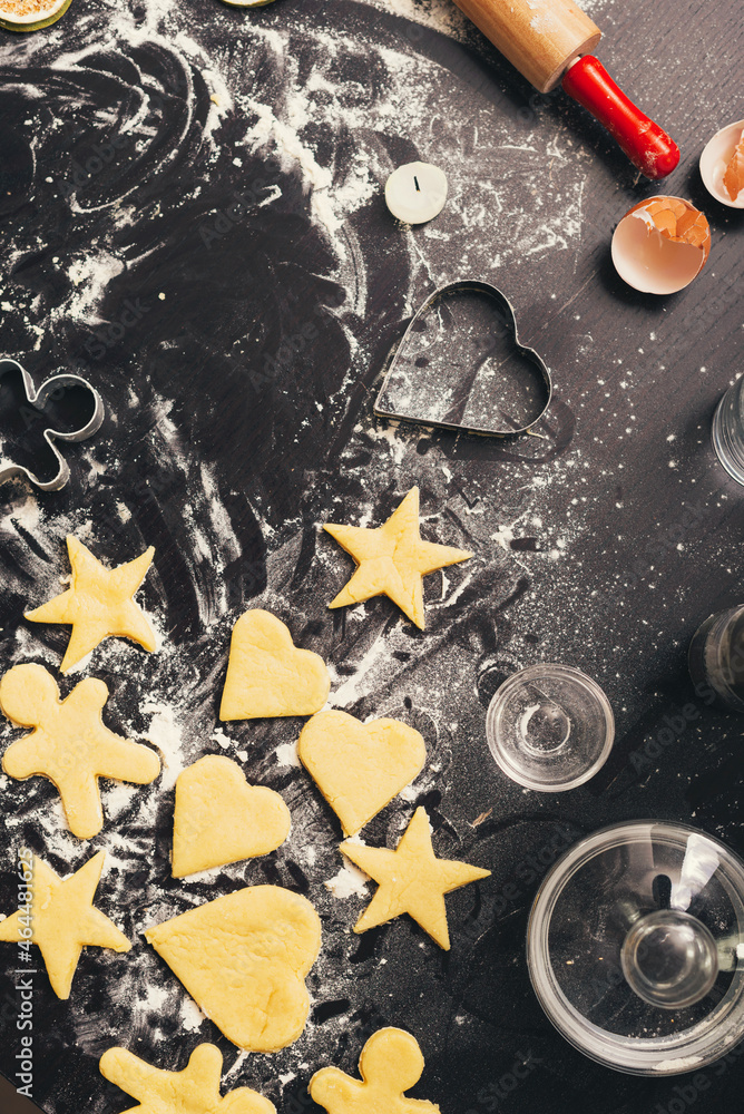 Vertical photo of some raw gingerbread forms on black table. Vertical photo of some raw gingerbread forms on black table.