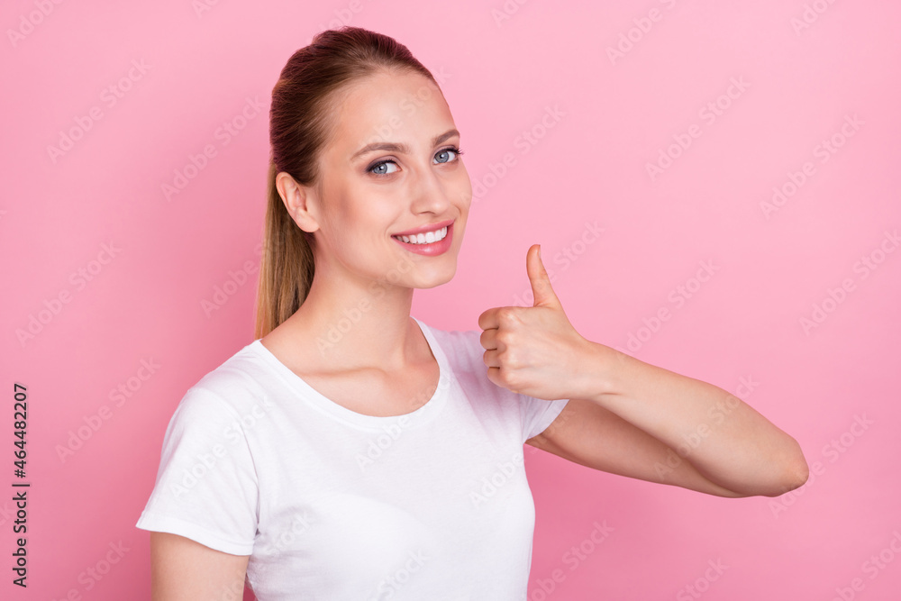 Photo of young woman happy positive smile show thumb-up like perfect fine ad isolated over pink color background Photo of young woman happy positive smile show thumb-up like perfect fine ad isolated over pink color background