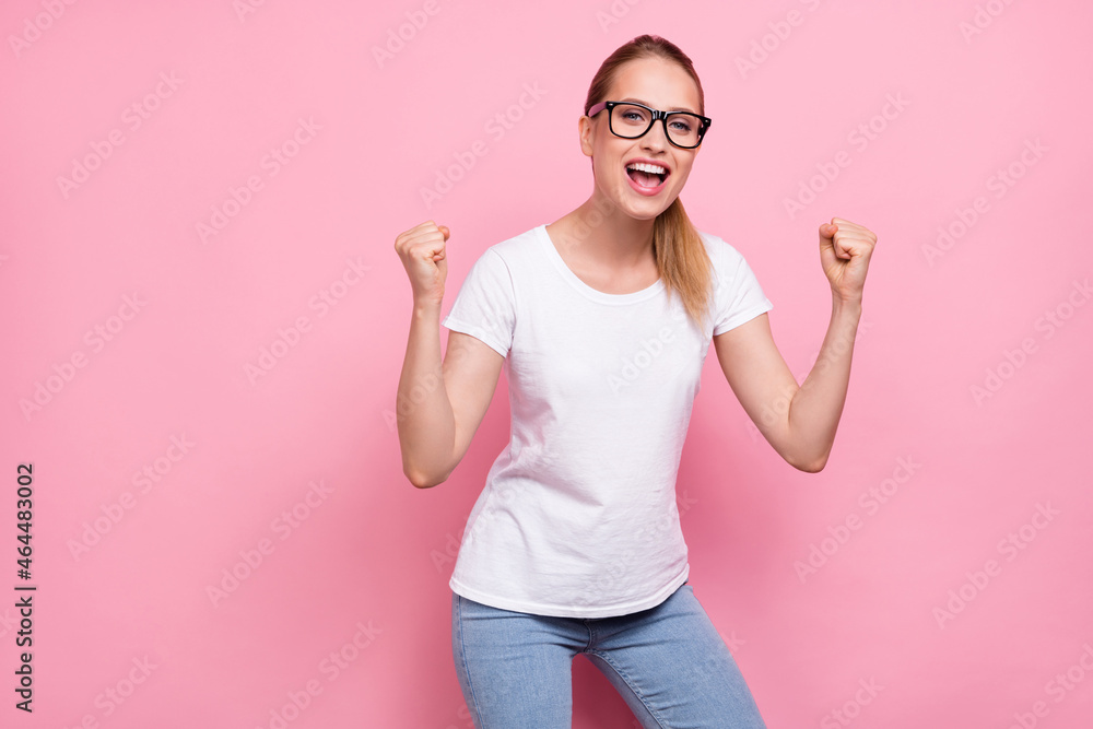 Photo of young woman happy positive smile rejoice victory success winner isolated over pink color background Photo of young woman happy positive smile rejoice victory success winner isolated over pink color background