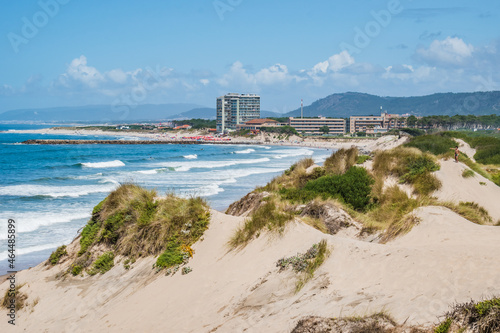 Dunes on Fão beach with Atlantic Ocean waves and Esposende architecture in the background, PORTUGAL photo