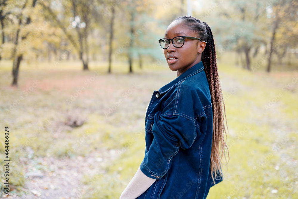 Young beautiful african woman walking in the autumn park Young beautiful african woman walking in the autumn park