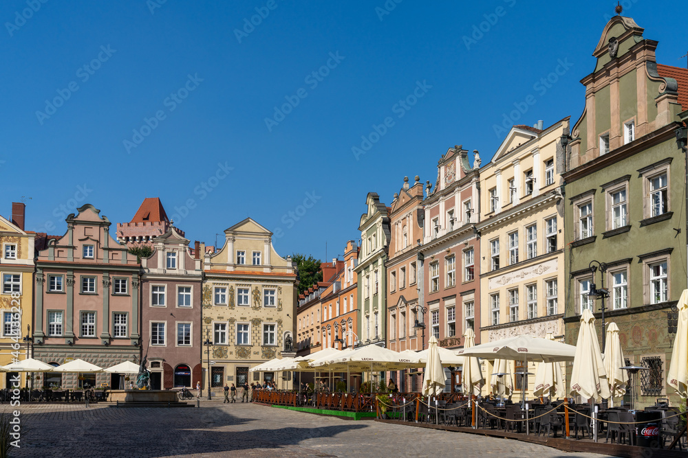view of the colorful Renaissance architecture buildings on the old market square of Poznan with outdoor restaurants