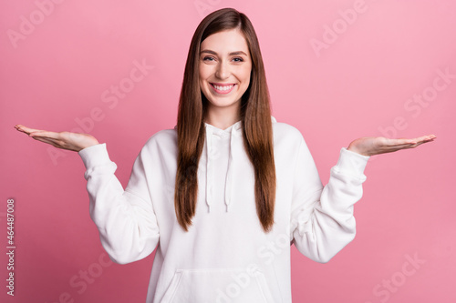 Photo of young woman happy positive smile hold hand product advert pros cons solution isolated over pink color background