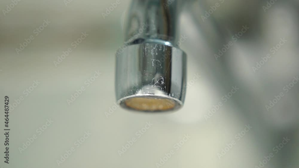 Water is dripping from tap. Macro shooting. Using water resources. Turn off the faucet Water is dripping from tap. Macro shooting. Using water resources. Turn off the faucet