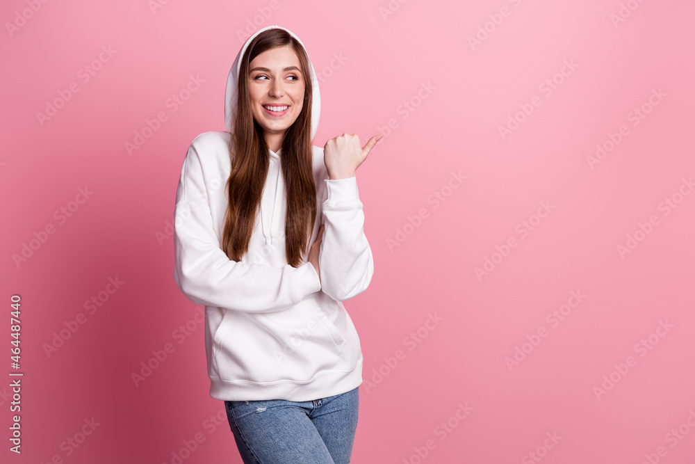 Photo of young girl happy positive smile look poitn thumb empty space ad promo suggest isolated over pastel color background Photo of young girl happy positive smile look poitn thumb empty space ad promo suggest isolated over pastel color background