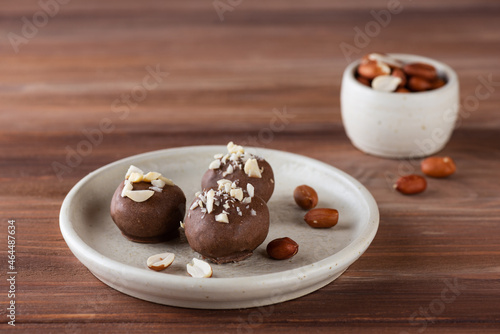 Chocolates with peanuts on a plate. Sugar, gluten and lactose free, vegan.