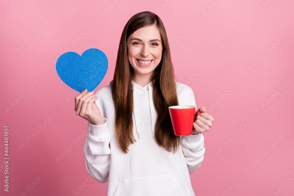 Photo of young girl happy positive smile hold heart love drink coffee isolated over pastel color background Photo of young girl happy positive smile hold heart love drink coffee isolated over pastel color background