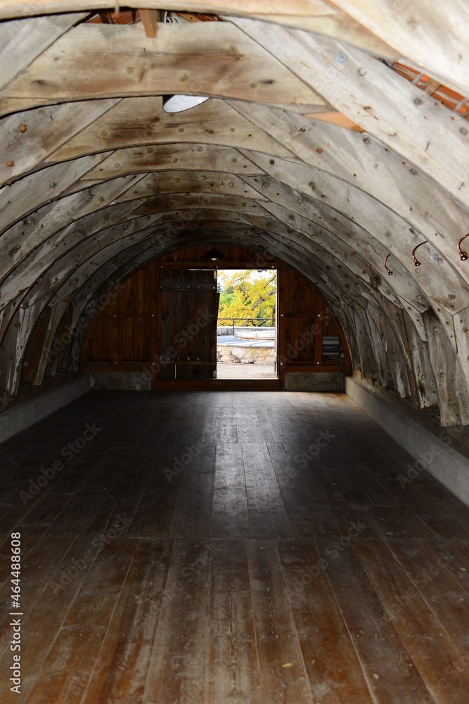 old stone arched building with wooden floors