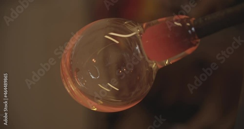 Professional glassblower working with glass at the workshop